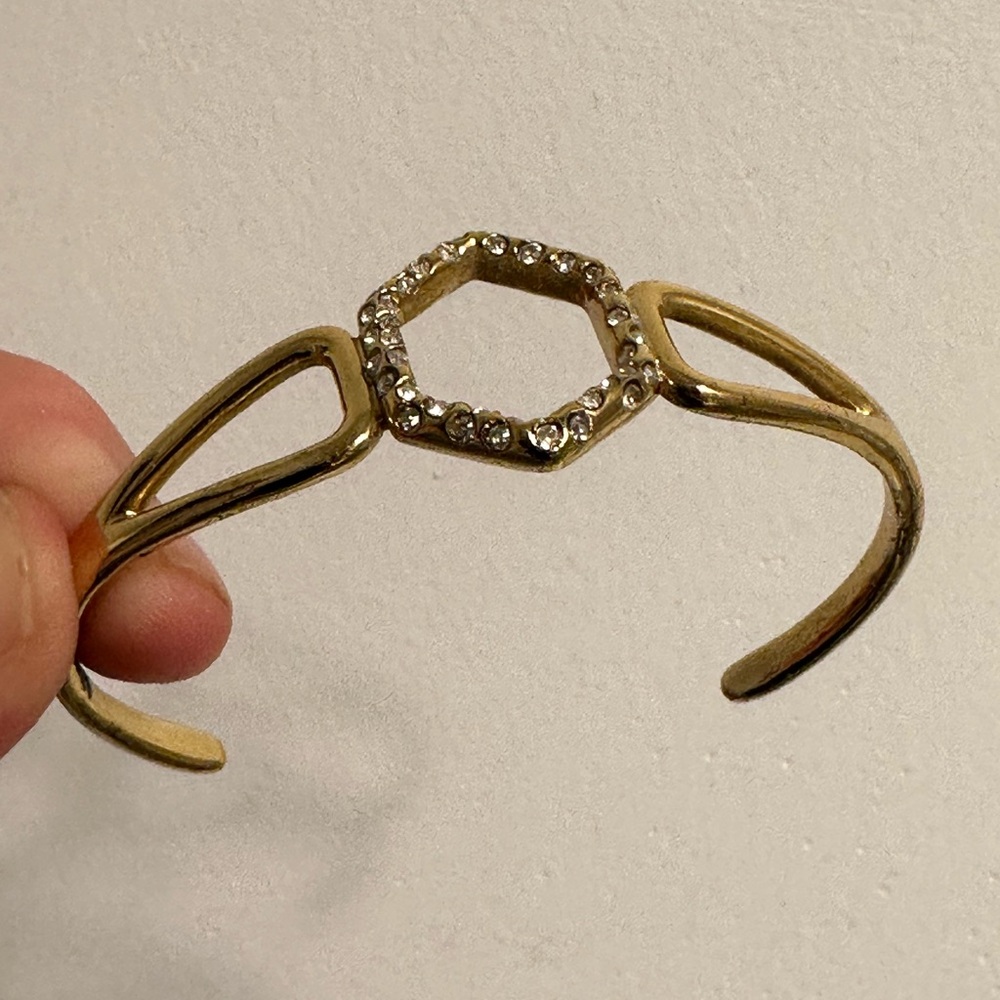 Gold metal bracelet with crystals.